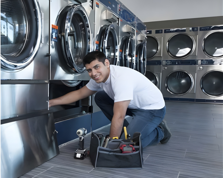 Laundry technician working on front-load washers inside a clean, modern laundromat