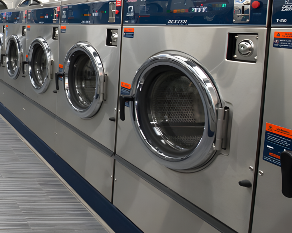 Row of commercial washers ready for use in a Miami Beach laundry room.