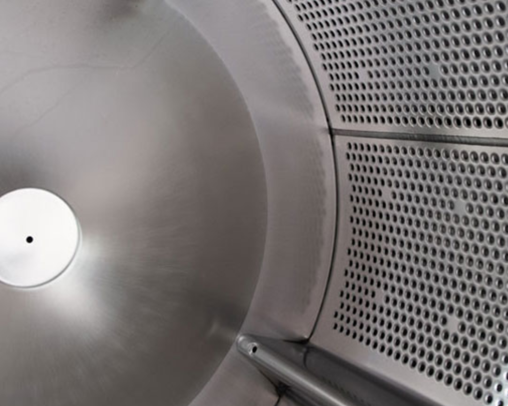 Interior of a Speed Queen commercial washer highlighting the stainless steel drum design built for durability and consistent performance in Morrisville, NC.