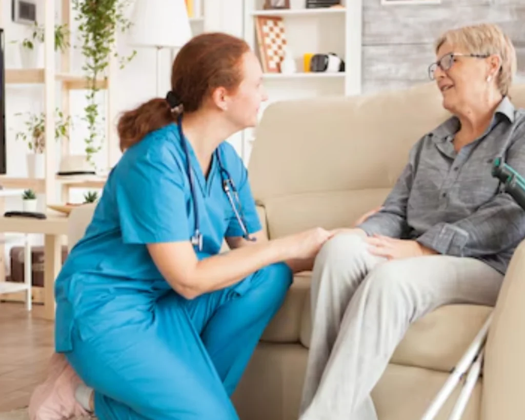 Memory care staff member assisting a resident in a comfortable Greer, SC care setting.