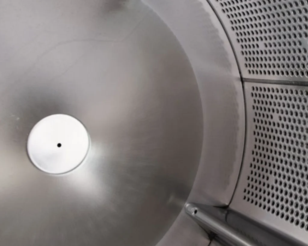 Close-up of a stainless commercial washer drum for Southeastern Laundry laundromat equipment in Orlando.