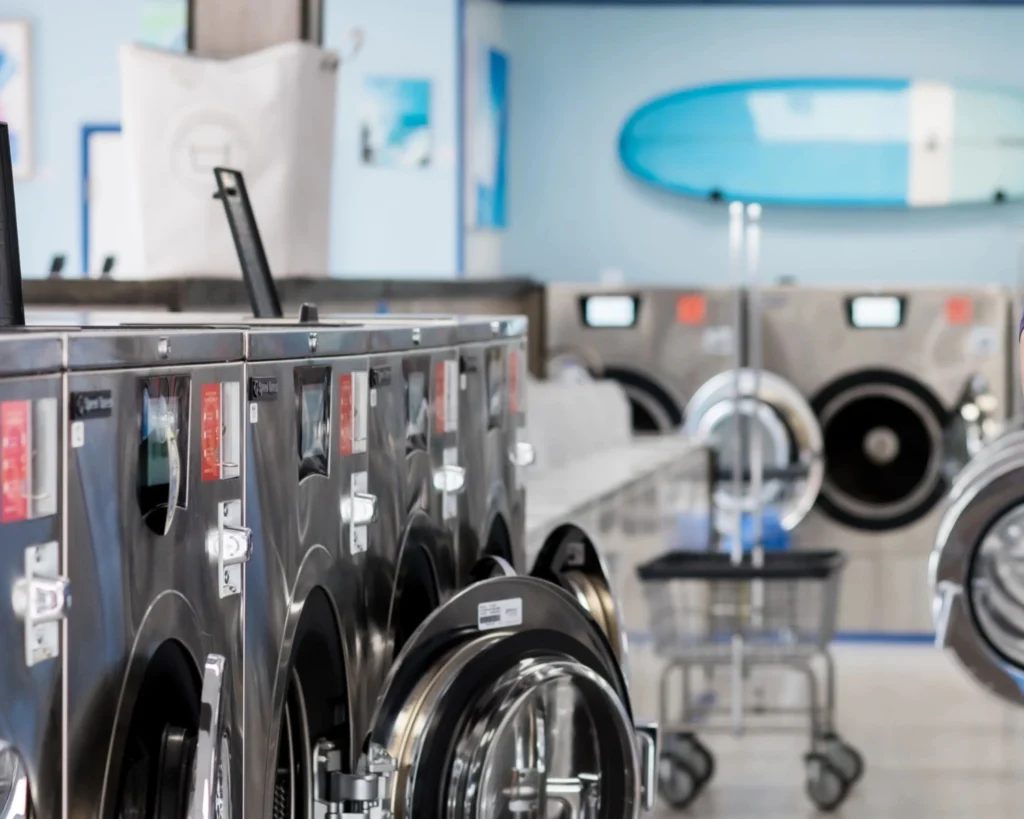 Clean laundromat with commercial washers showing the value of dependable equipment service support