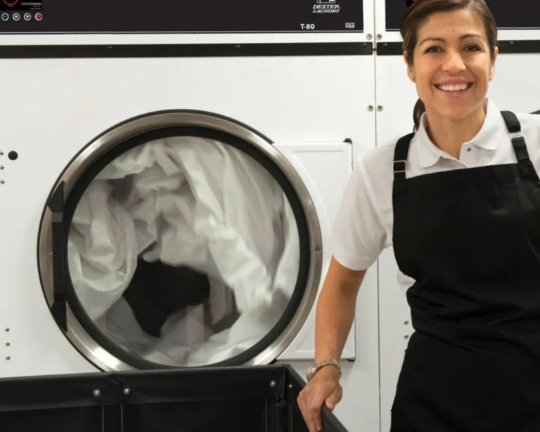 Southeastern Laundry staff member stands beside Dexter® commercial laundry equipment in Charlotte.