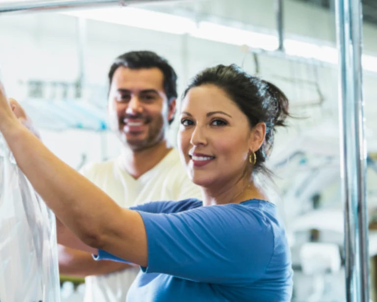 Two people discuss laundry equipment needs during a Southeastern Laundry request a quote consultation in Charlotte.