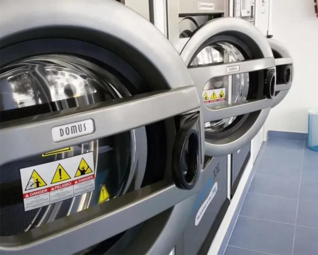 Domus® commercial laundry equipment shown in a laundry room for Southeastern Laundry in Kentucky.