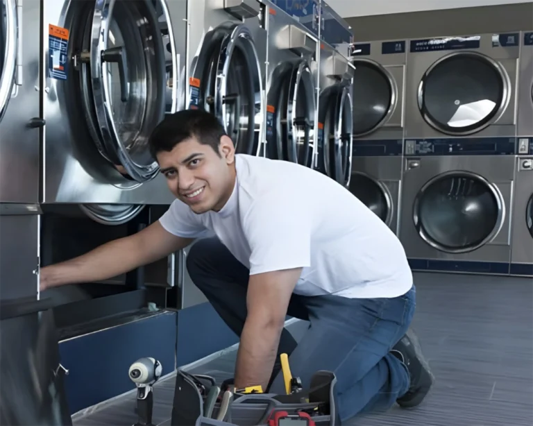 Technician servicing commercial laundry equipment in a South Carolina laundry room for Southeastern Laundry.