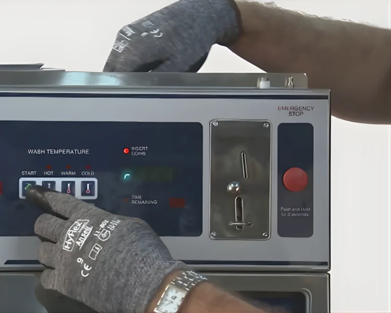 Southeastern Laundry technician performs commercial washer repair on a control panel in Texas.