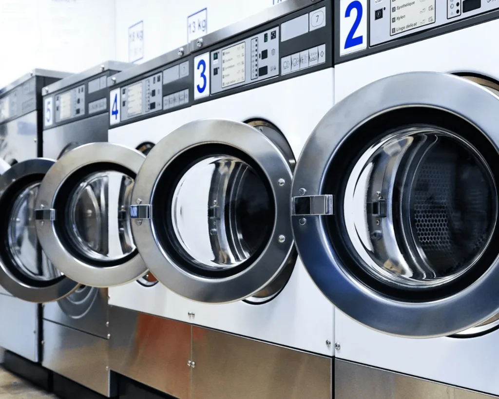 Apartment laundry room design with clearly numbered commercial washers and easy-to-identify machine doors