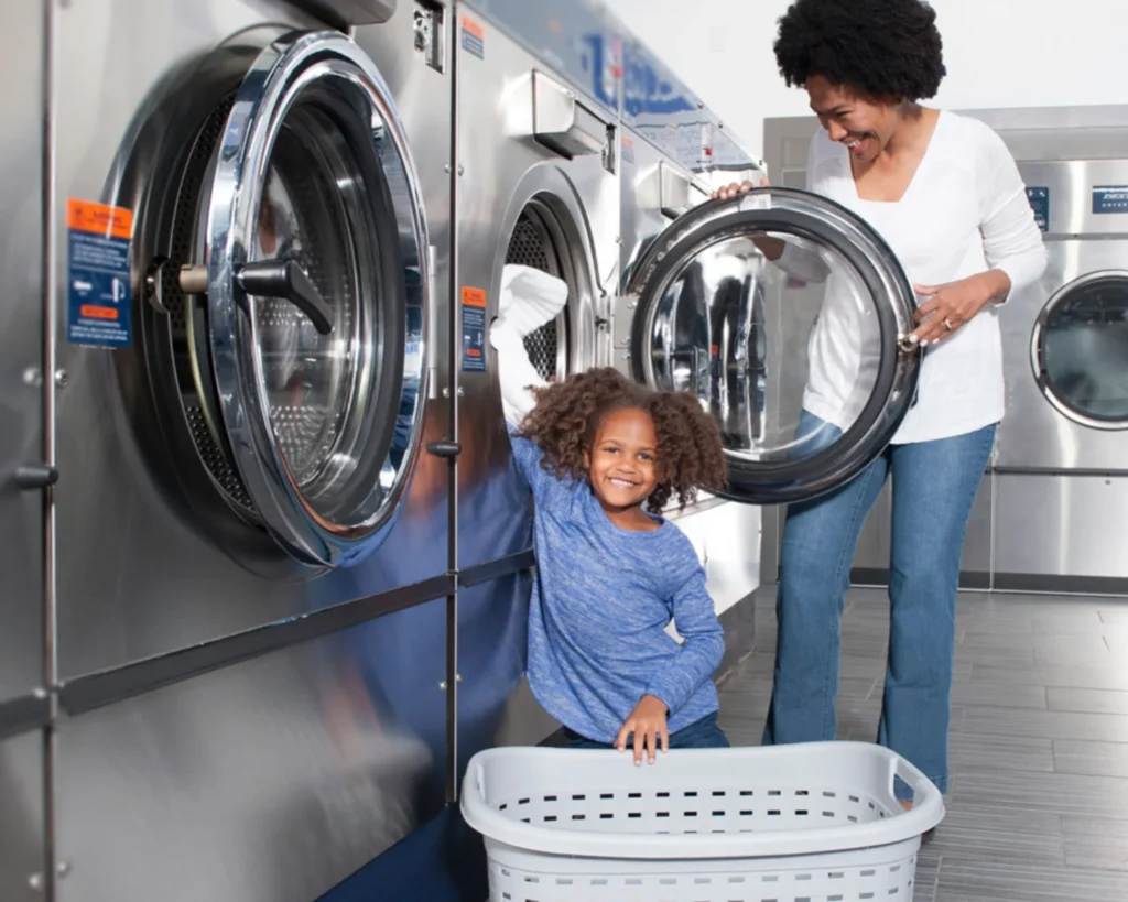 Apartment laundry room design with a parent and child using front-loading commercial washers