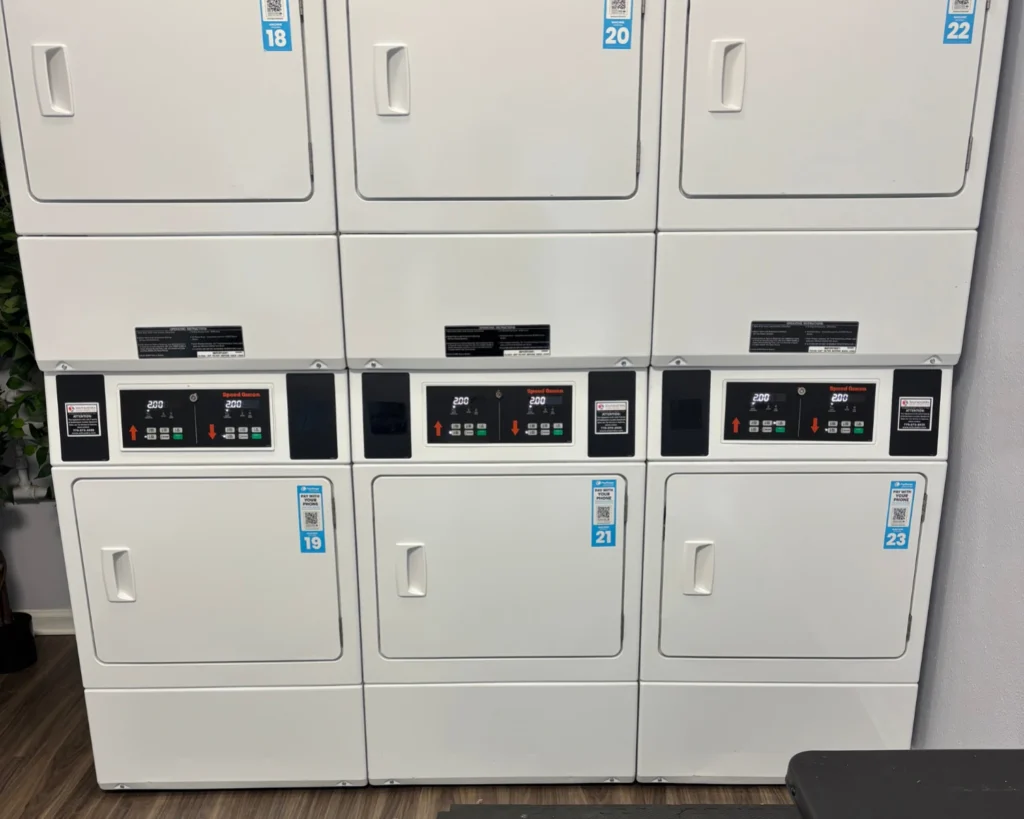 Stacked commercial dryers with digital payment options that can help increase your laundromat profits